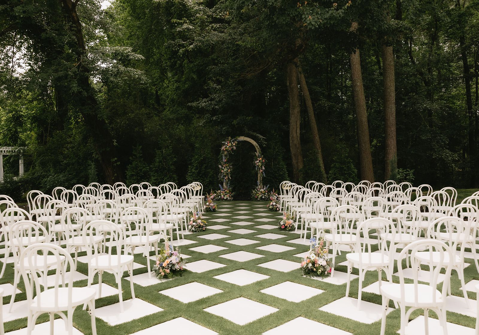 Decorated outdoor ceremony space with vibrant flowers.