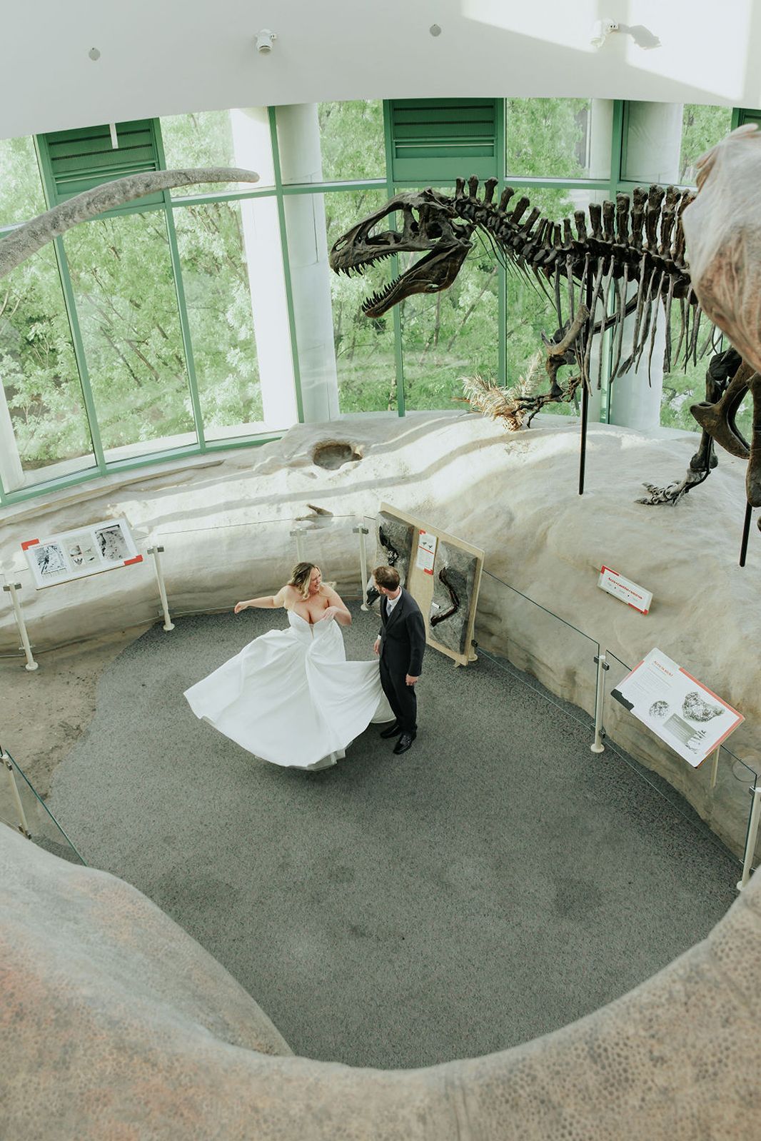 Couple dancing in front of dinosaur fossils at NC Museum of Natural Sciences.
