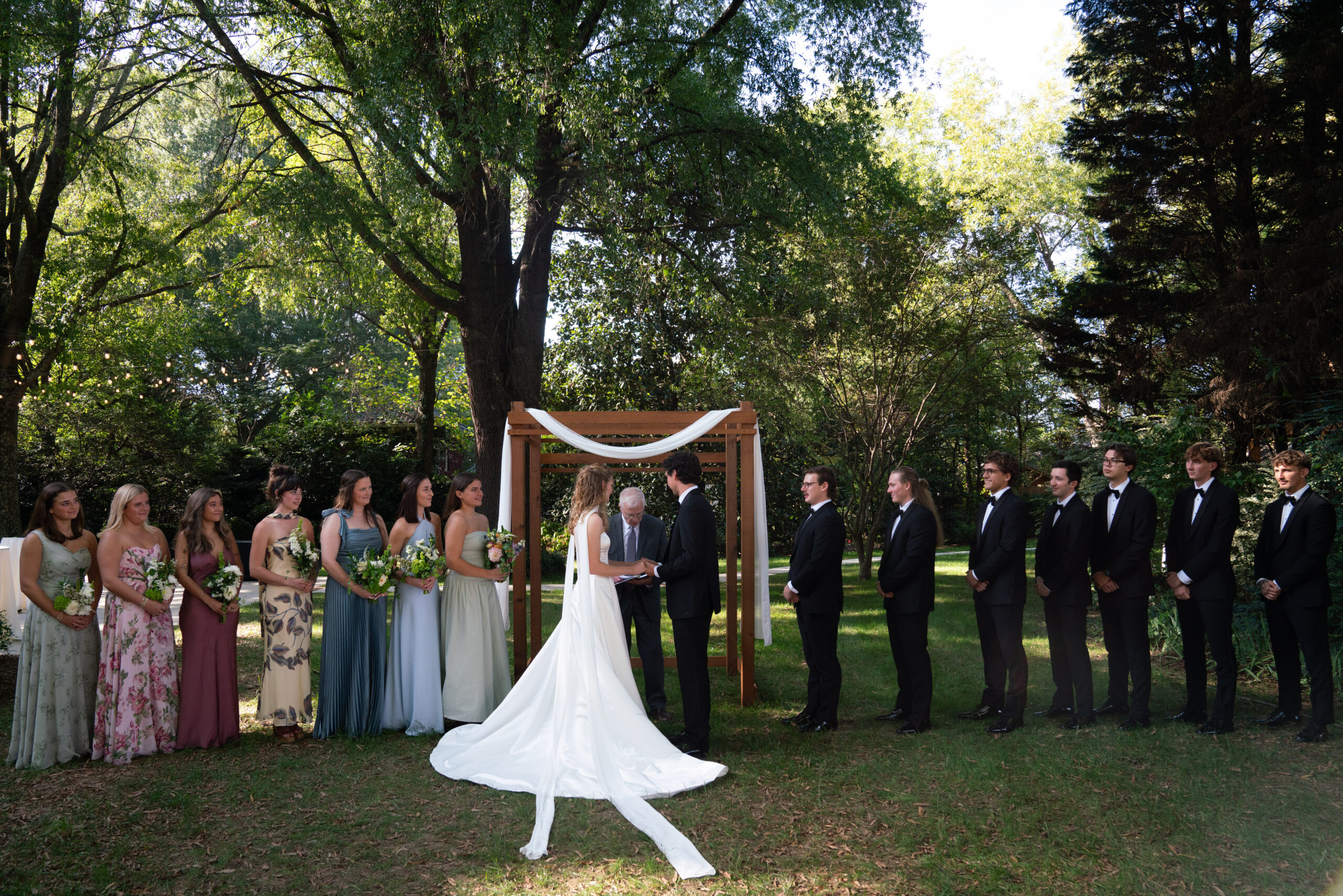 Wedding officiant in NC marrying couple at altar.